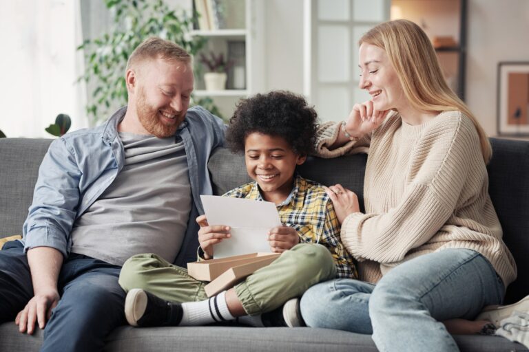 Happy child reading a letter about adoption