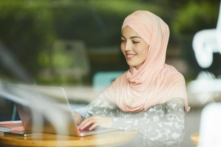 Muslim woman answering e-mails