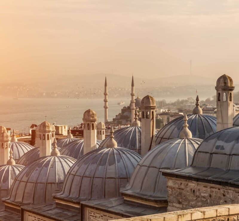 The domes of Suleymaniye Mosque, with the Bosphorus Strait and Galata Bridge in the distance.